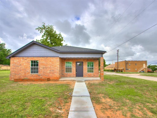 3100 NE 17th St, Oklahoma City, OK 73121 - view of front of home with brick siding, a front lawn, and a porch