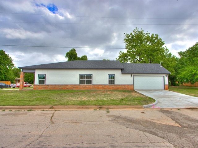 3100 NE 17th St, Oklahoma City, OK 73121 - view of front of home featuring driveway, a garage, a front yard, and brick siding