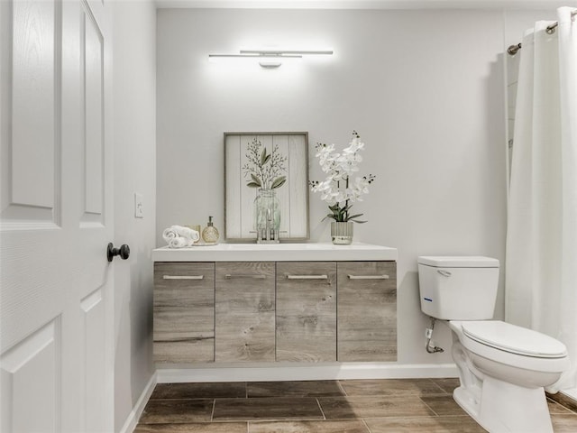 3100 NE 17th St, Oklahoma City, OK 73121 - full bath with toilet, baseboards, vanity, and wood tiled floors