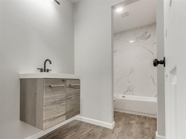 3100 NE 17th St, Oklahoma City, OK 73121 - bathroom with wood tiled floors, vanity, and baseboards