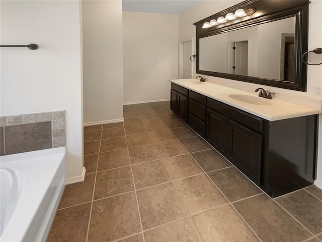 bathroom featuring double vanity, a sink, a garden tub, and tile patterned flooring