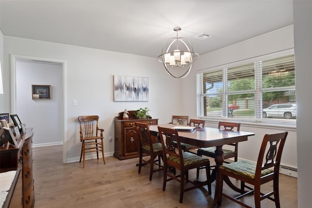 3101 NW 70th St, Oklahoma City, OK 73116 - dining room with baseboards, light wood finished floors, visible vents, a notable chandelier, and baseboard heating