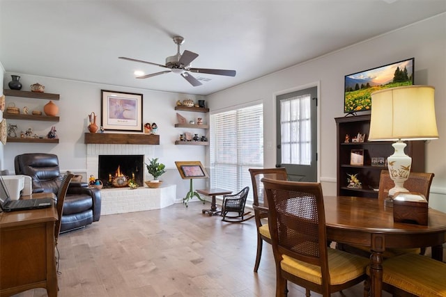 3101 NW 70th St, Oklahoma City, OK 73116 - dining room featuring a fireplace, ceiling fan, and light wood-style flooring