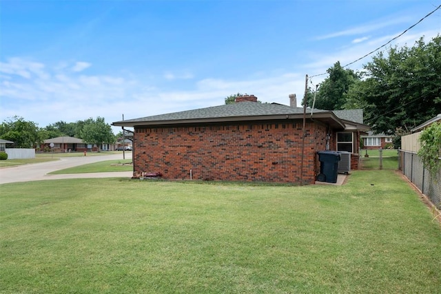 3101 NW 70th St, Oklahoma City, OK 73116 - view of property exterior with brick siding, fence, and a lawn