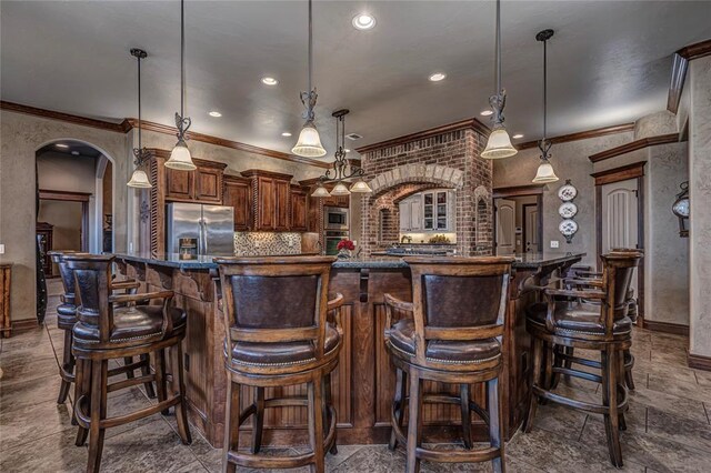 8301 NW 146th St, Oklahoma City, OK 73142 - kitchen with arched walkways, ornamental molding, and appliances with stainless steel finishes
