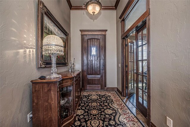 8301 NW 146th St, Oklahoma City, OK 73142 - foyer entrance with baseboards, ornamental molding, a textured wall, and tile patterned flooring