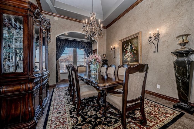 8301 NW 146th St, Oklahoma City, OK 73142 - dining space featuring an inviting chandelier, a textured wall, ornamental molding, baseboards, and arched walkways
