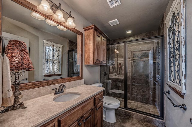 8301 NW 146th St, Oklahoma City, OK 73142 - bathroom featuring toilet, a shower stall, a textured ceiling, and visible vents