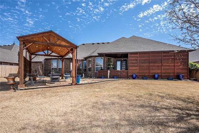 8301 NW 146th St, Oklahoma City, OK 73142 - rear view of property featuring fence, a patio, a gazebo, roof with shingles, and a lawn