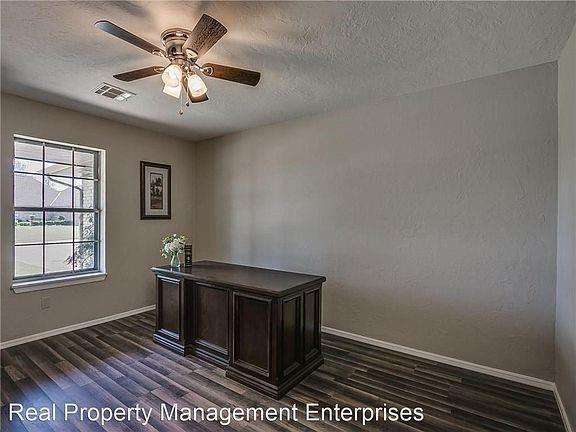 2325 NW 119th St, Oklahoma City, OK 73120 - unfurnished office with dark wood-type flooring, baseboards, a textured ceiling, ceiling fan, and visible vents