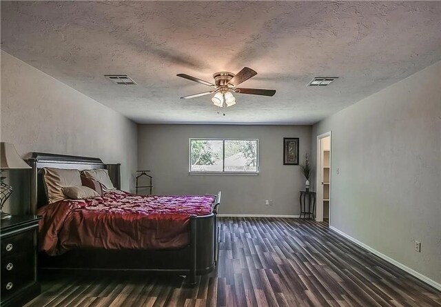 2325 NW 119th St, Oklahoma City, OK 73120 - bedroom with dark wood-type flooring, baseboards, a textured ceiling, and visible vents