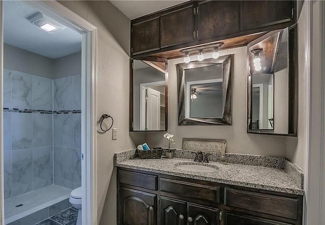2325 NW 119th St, Oklahoma City, OK 73120 - full bathroom featuring toilet, tiled shower, and vanity