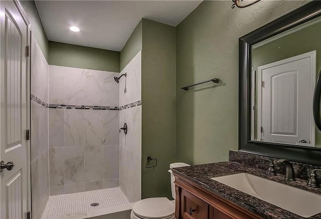 2325 NW 119th St, Oklahoma City, OK 73120 - bathroom with toilet, vanity, and tiled shower