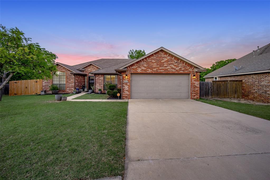 2833 Weymouth Ct, Norman, OK 73071 - ranch-style house with a garage, driveway, brick siding, and roof with shingles