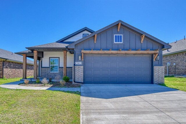 13412 Arrowhead Blvd, Yukon, OK 73099 - view of front of property with concrete driveway, an attached garage, brick siding, and board and batten siding