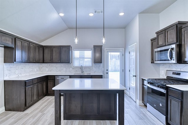 13412 Arrowhead Blvd, Yukon, OK 73099 - kitchen with stainless steel appliances, dark brown cabinets, visible vents, a sink, and light countertops