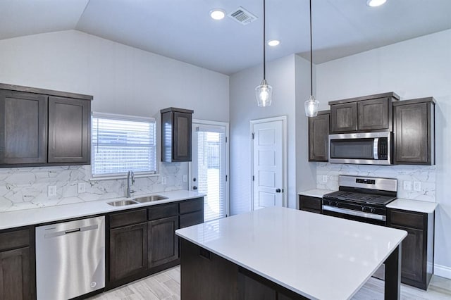 13412 Arrowhead Blvd, Yukon, OK 73099 - kitchen with a sink, stainless steel appliances, visible vents, light countertops, and dark brown cabinets