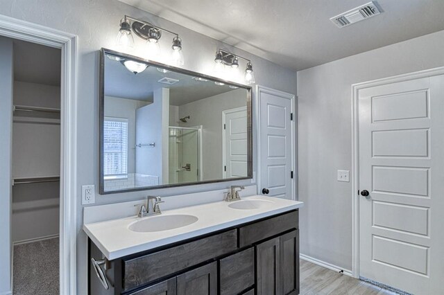 13412 Arrowhead Blvd, Yukon, OK 73099 - full bath featuring a sink, double vanity, a stall shower, and visible vents