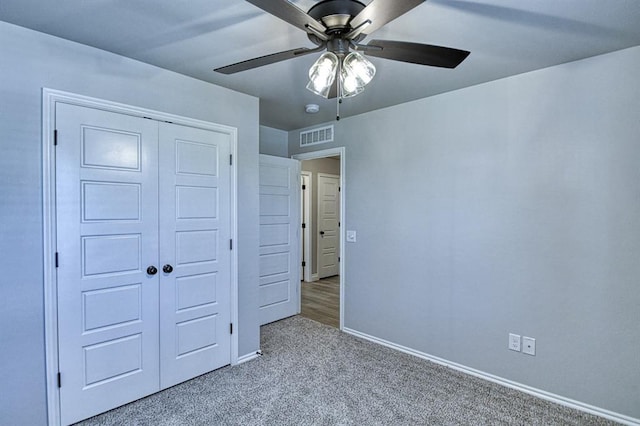 13412 Arrowhead Blvd, Yukon, OK 73099 - unfurnished bedroom with a closet, carpet floors, visible vents, baseboards, and ceiling fan