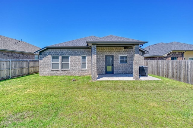 13412 Arrowhead Blvd, Yukon, OK 73099 - back of property featuring a lawn, a patio, brick siding, and a fenced backyard