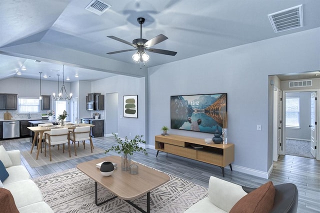 13412 Arrowhead Blvd, Yukon, OK 73099 - living area with lofted ceiling, light wood-style flooring, and visible vents