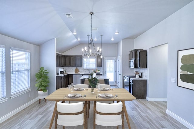 13412 Arrowhead Blvd, Yukon, OK 73099 - dining area featuring visible vents, light wood-style flooring, lofted ceiling, and a notable chandelier