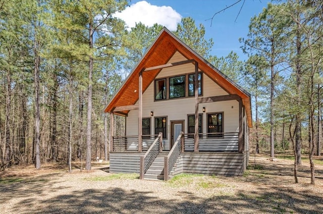 203 Secluded Cir, Broken Bow, OK 74728 - rustic home featuring a porch and stairway