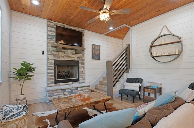 203 Secluded Cir, Broken Bow, OK 74728 - living room featuring wood ceiling, wooden walls, wood finished floors, stairs, and a ceiling fan