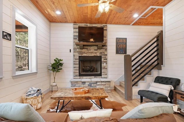 203 Secluded Cir, Broken Bow, OK 74728 - living room with wood ceiling, wood finished floors, wood walls, stairs, and ceiling fan