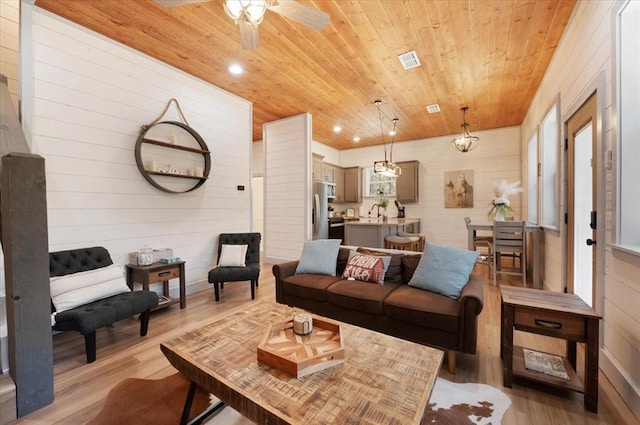 203 Secluded Cir, Broken Bow, OK 74728 - living room with wood ceiling, light wood finished floors, wood walls, ceiling fan, and recessed lighting