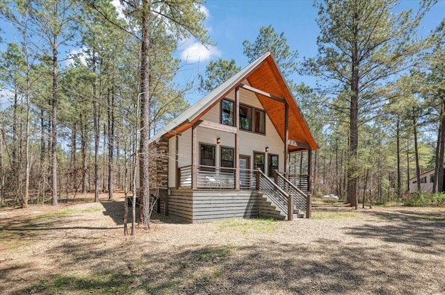 203 Secluded Cir, Broken Bow, OK 74728 - rustic home with covered porch and stairway