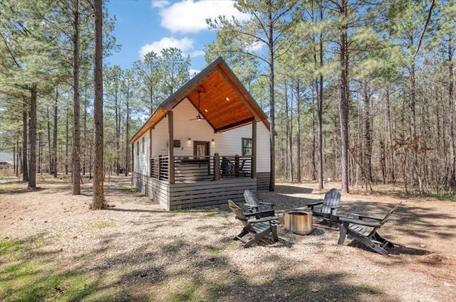 203 Secluded Cir, Broken Bow, OK 74728 - back of house with a wooded view and a fire pit