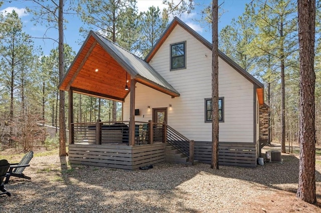 203 Secluded Cir, Broken Bow, OK 74728 - rear view of property with a deck and a metal roof