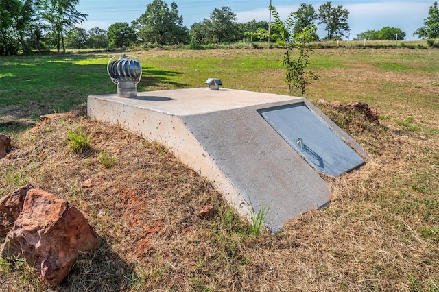 view of storm shelter featuring a yard