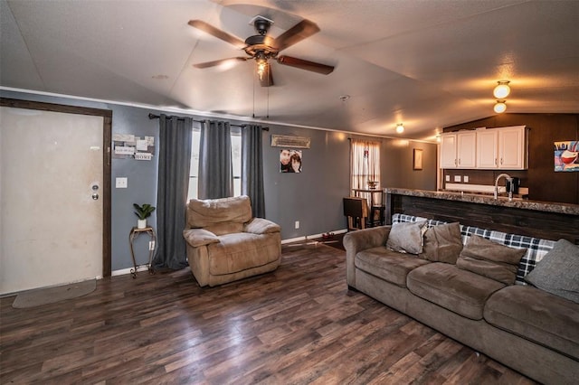living area featuring ceiling fan, lofted ceiling, dark wood-style floors, and baseboards