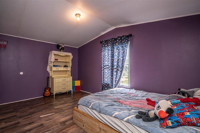 bedroom with lofted ceiling and wood finished floors