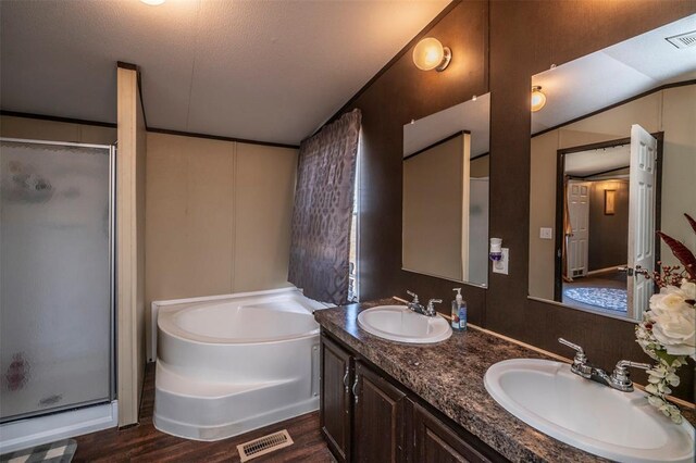 bathroom with a shower stall, a garden tub, wood finished floors, a sink, and visible vents