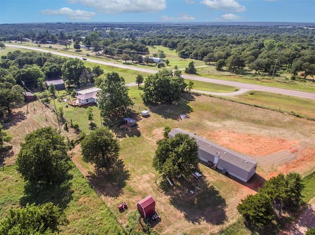 birds eye view of property with a rural view and a wooded view