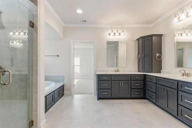 15632 Flora Ave, Edmond, OK 73013 - full bathroom featuring double vanity, a stall shower, a garden tub, ornamental molding, and tile patterned floors