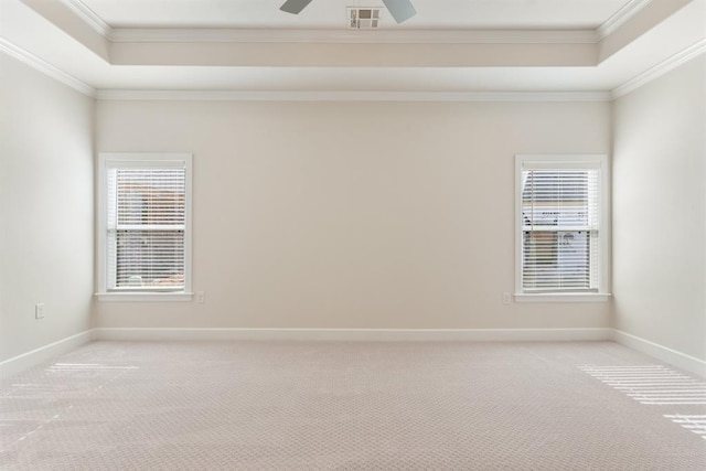 15632 Flora Ave, Edmond, OK 73013 - unfurnished room with a tray ceiling, light colored carpet, ornamental molding, healthy amount of natural light, and baseboards