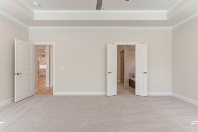 15632 Flora Ave, Edmond, OK 73013 - unfurnished bedroom with a tray ceiling, light colored carpet, ornamental molding, and baseboards