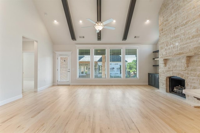 15632 Flora Ave, Edmond, OK 73013 - unfurnished living room featuring a ceiling fan, a fireplace, high vaulted ceiling, beamed ceiling, and light wood-style floors