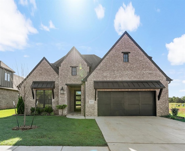 15632 Flora Ave, Edmond, OK 73013 - view of front of home with brick siding, driveway, a front lawn, and a garage