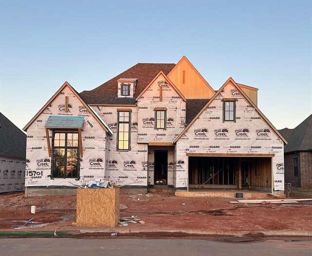 property in mid-construction featuring roof with shingles