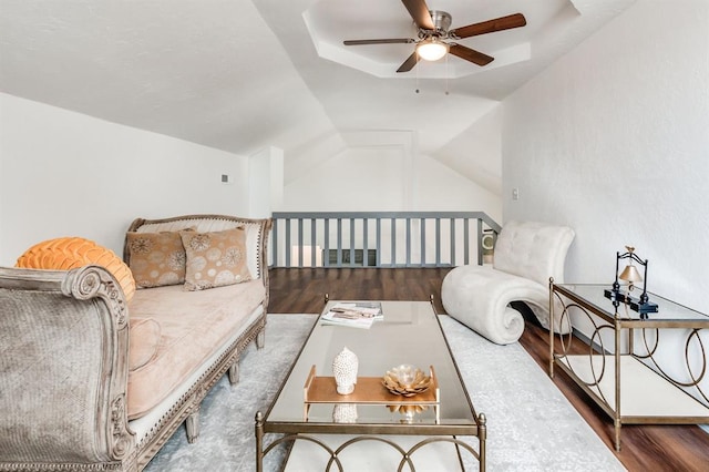 sitting room with visible vents, a ceiling fan, wood finished floors, and vaulted ceiling