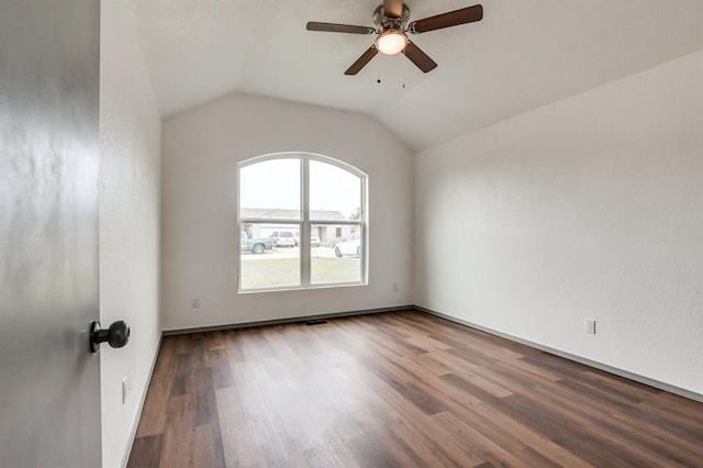 unfurnished room with lofted ceiling, baseboards, a ceiling fan, and wood finished floors