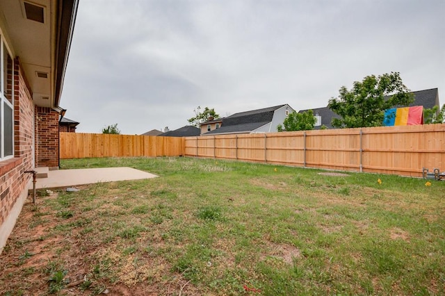 view of yard with a fenced backyard and a patio
