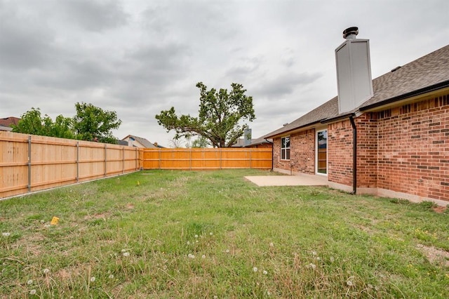 view of yard featuring a patio and a fenced backyard