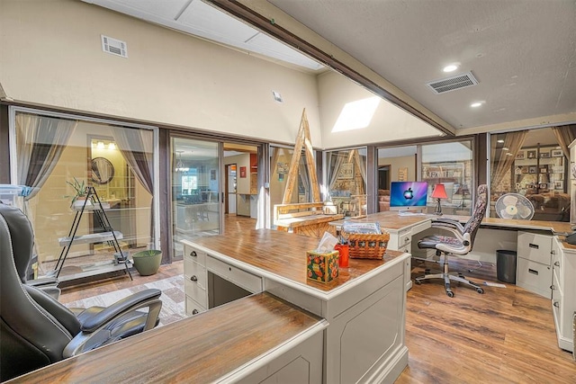 home office with recessed lighting, light wood-type flooring, and visible vents