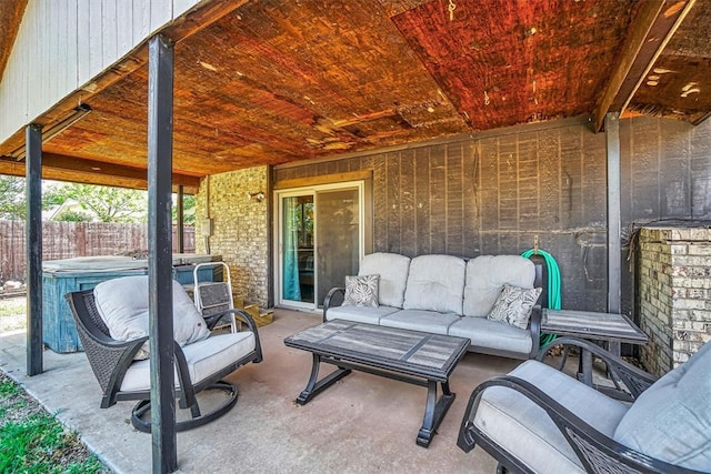 view of patio featuring an outdoor hangout area, a hot tub, and fence